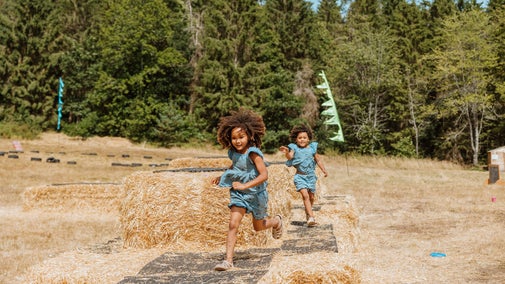 Summer of Play Comer Woods Girls on Straw bales Lucy Rebecca Photography